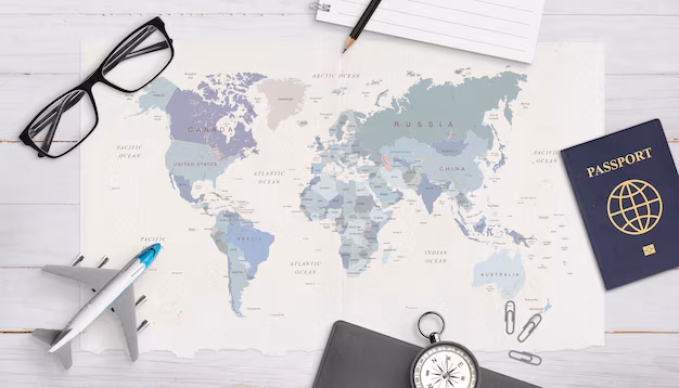 Travel documents and items on a wooden surface