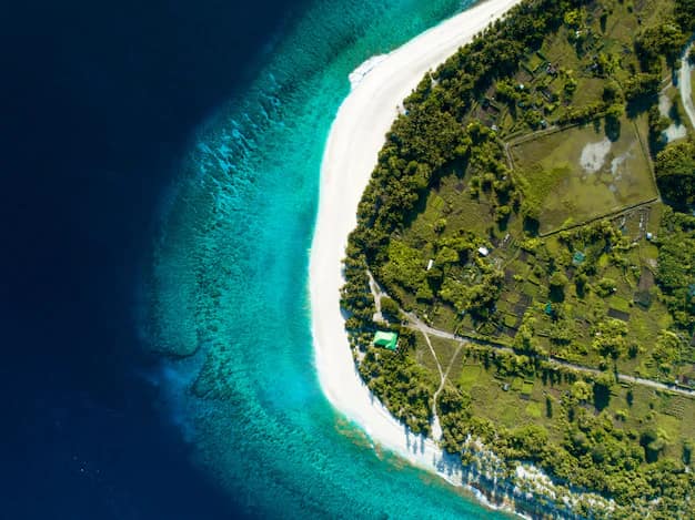 Aerial shot of a Maldives island, beach and clear blue sea