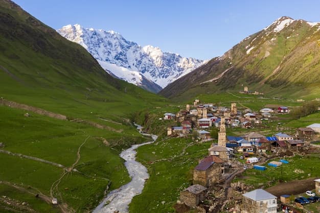 Aerial view of the historic village of Ushguli in Upper Svaneti, Georgia, with medieval stone defensive towers among houses below high Caucasus peaks