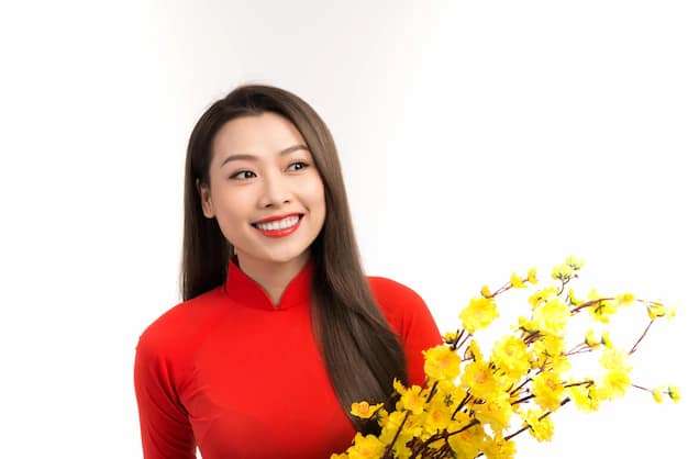 Woman in traditional Vietnamese ao dai among blossoms