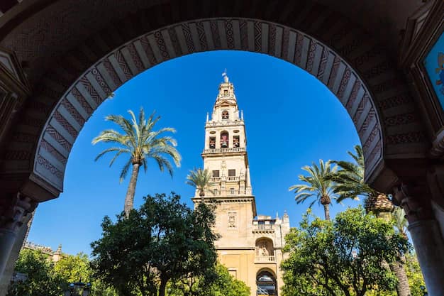 Low-angle view of the bell tower of the Great Mosque-Cathedral of Cordoba against a clear blue sky